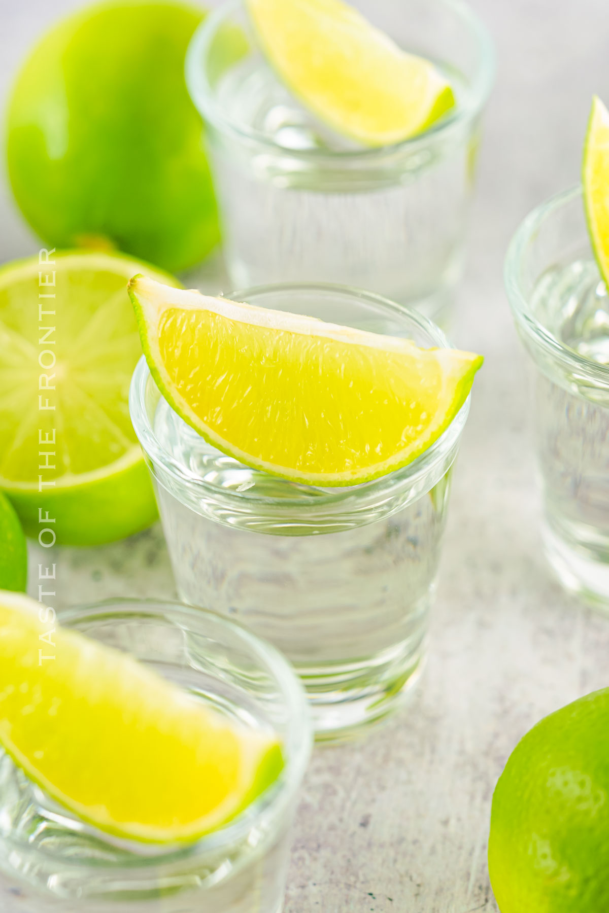 cocktail served with lime wedge