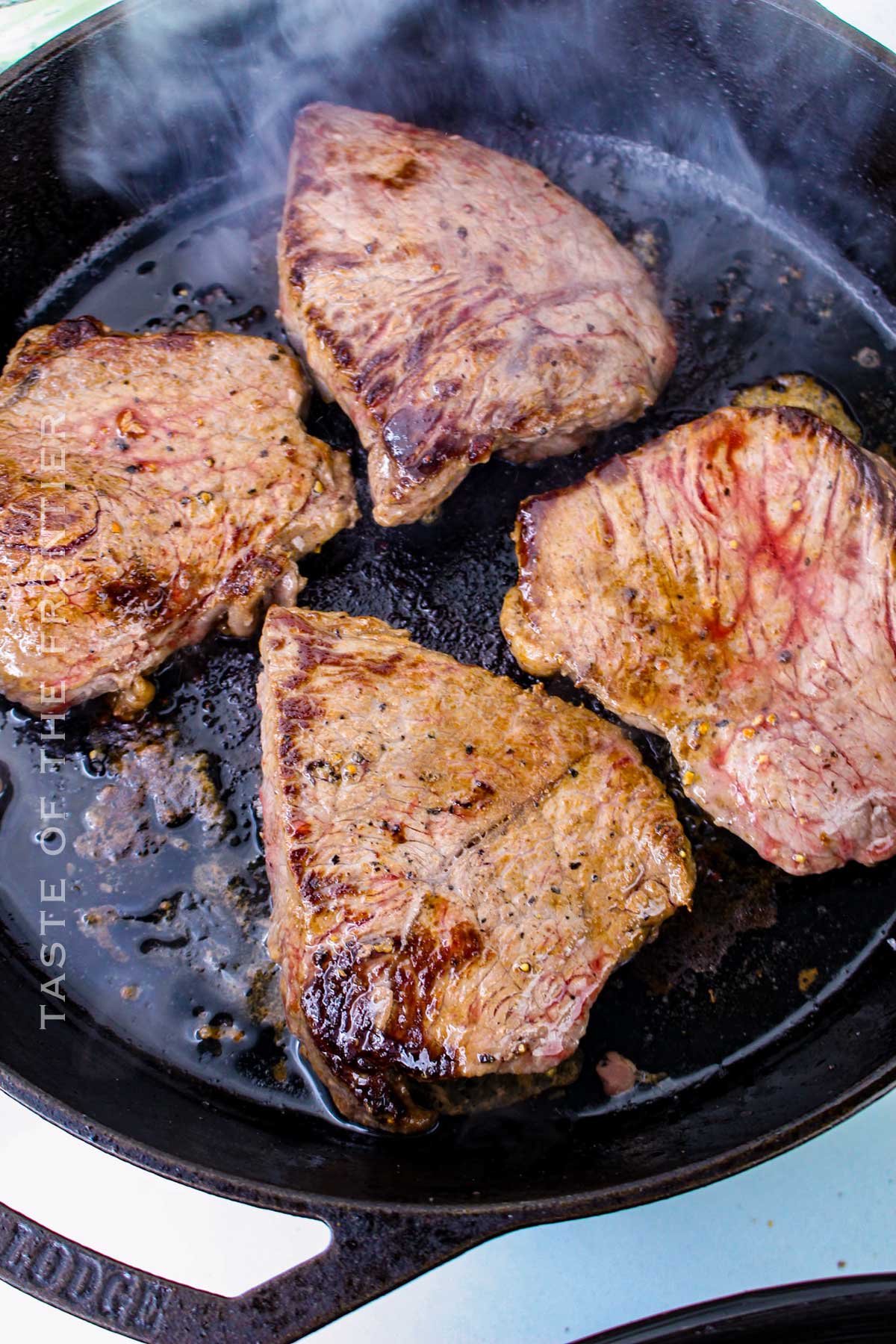 cooking the steak on the stovetop