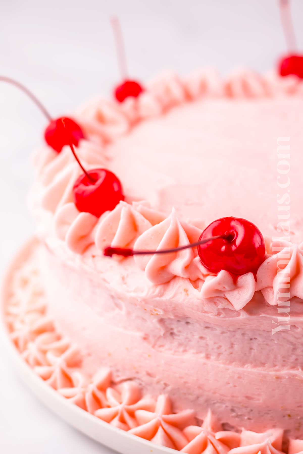 frosted cake with cherries